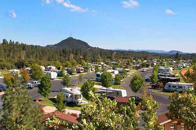 RVs parked in campsites at Jackson Rancheria Casino & RV Resort with a mountain landscape in the backdrop